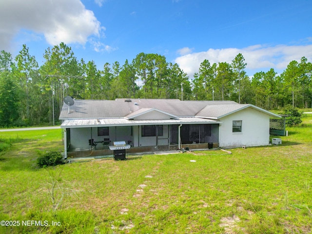23063 SW Edgewater Blvd, Dunnellon, FL 34431 - back of house featuring a sunroom and a yard