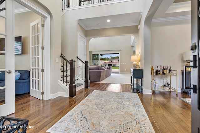 361 Amalurra Trl, Saint Johns, FL 32259 - entryway with arched walkways, ornamental molding, wood finished floors, french doors, and stairway