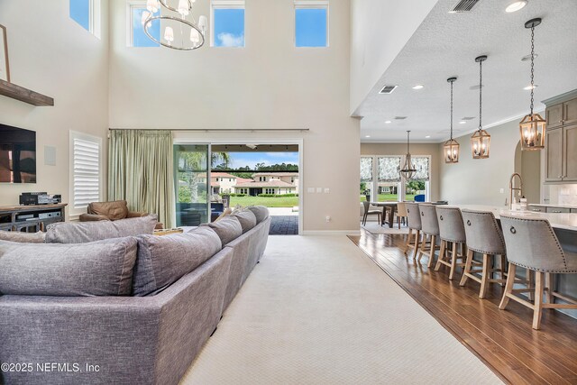 361 Amalurra Trl, Saint Johns, FL 32259 - living room with a chandelier, a high ceiling, wood finished floors, baseboards, and recessed lighting