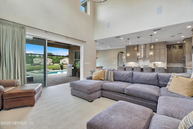 361 Amalurra Trl, Saint Johns, FL 32259 - living area with a high ceiling, healthy amount of natural light, arched walkways, light carpet, and recessed lighting
