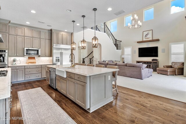 361 Amalurra Trl, Saint Johns, FL 32259 - kitchen with gray cabinetry, stainless steel appliances, a sink, open floor plan, and recessed lighting