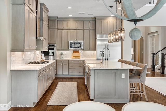 361 Amalurra Trl, Saint Johns, FL 32259 - kitchen featuring stainless steel appliances, gray cabinetry, a kitchen breakfast bar, light stone counters, and recessed lighting