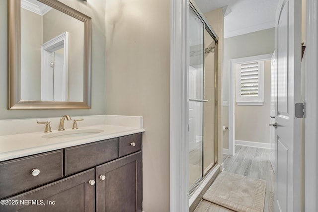 361 Amalurra Trl, Saint Johns, FL 32259 - full bathroom featuring ornamental molding, a stall shower, vanity, baseboards, and wood finished floors