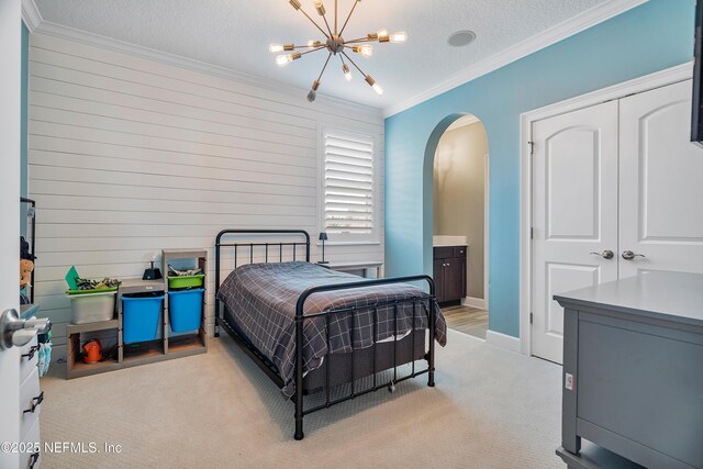 361 Amalurra Trl, Saint Johns, FL 32259 - bedroom featuring arched walkways, crown molding, a chandelier, light carpet, and baseboards