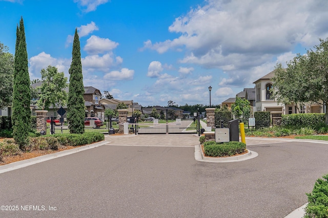 361 Amalurra Trl, Saint Johns, FL 32259 - view of asphalt street featuring street lighting, a gate, a residential view, curbs, and a gated entry