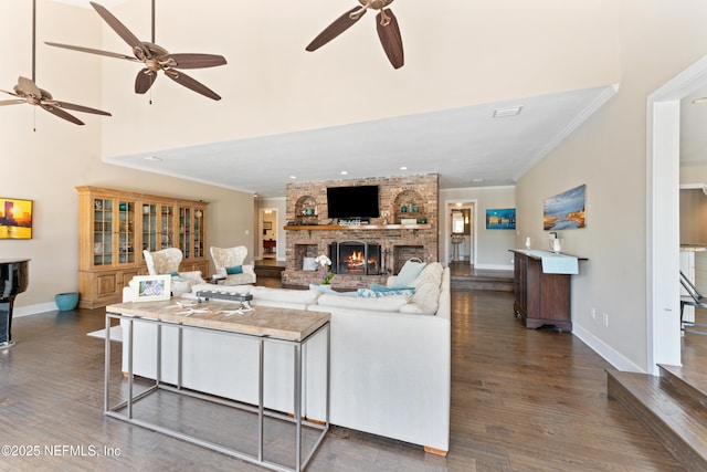 24544 Deer Trace Dr, Ponte Vedra Beach, FL 32082 - living area with a ceiling fan, dark wood-style flooring, a brick fireplace, baseboards, and ornamental molding
