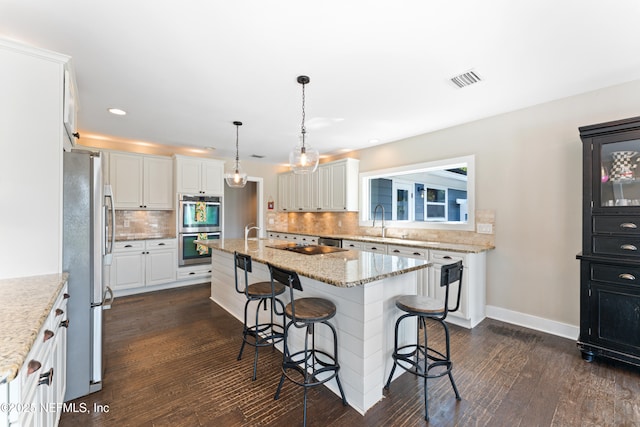 24544 Deer Trace Dr, Ponte Vedra Beach, FL 32082 - kitchen with appliances with stainless steel finishes, a sink, an island with sink, a kitchen breakfast bar, and white cabinets