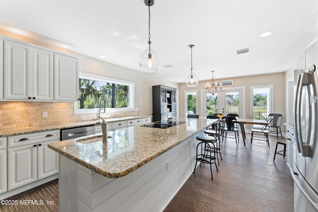 24544 Deer Trace Dr, Ponte Vedra Beach, FL 32082 - kitchen with healthy amount of natural light, appliances with stainless steel finishes, decorative backsplash, a kitchen island with sink, and recessed lighting