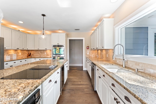 24544 Deer Trace Dr, Ponte Vedra Beach, FL 32082 - kitchen with stainless steel appliances, a sink, white cabinets, decorative backsplash, and recessed lighting