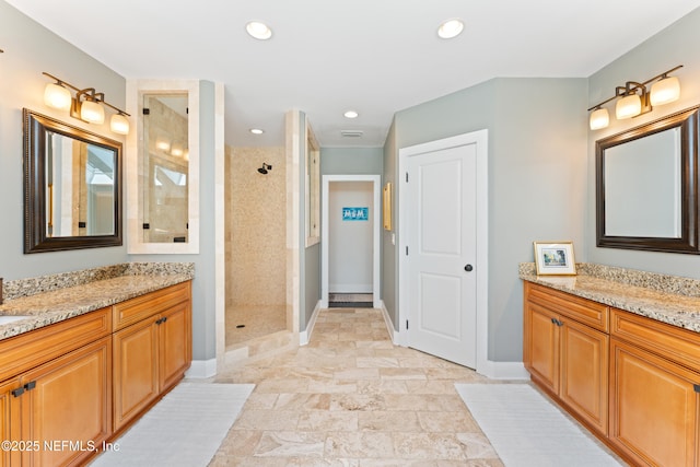 24544 Deer Trace Dr, Ponte Vedra Beach, FL 32082 - full bath with a tile shower, two vanities, recessed lighting, and baseboards