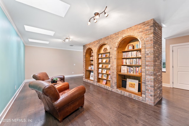 24544 Deer Trace Dr, Ponte Vedra Beach, FL 32082 - sitting room featuring a skylight, baseboards, built in shelves, wood finished floors, and ornamental molding