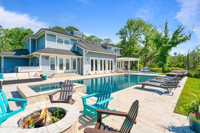 24544 Deer Trace Dr, Ponte Vedra Beach, FL 32082 - outdoor pool featuring french doors, a patio, fence, an outdoor living space with a fire pit, and a pergola