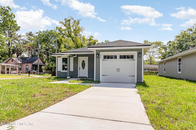 409 Willow Branch Ave, Jacksonville, FL 32254 - view of front of house with a garage, concrete driveway, a front lawn, and a shingled roof