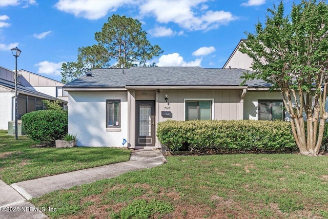 7142 Cypress Cove Rd Unit 39, Jacksonville, FL 32244 - ranch-style house with a front yard, a shingled roof, and central AC unit