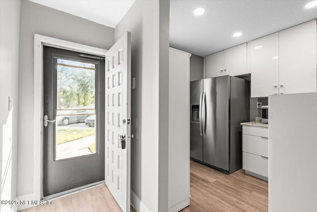 7142 Cypress Cove Rd Unit 39, Jacksonville, FL 32244 - kitchen featuring stainless steel refrigerator with ice dispenser, light wood-style floors, white cabinetry, light countertops, and recessed lighting