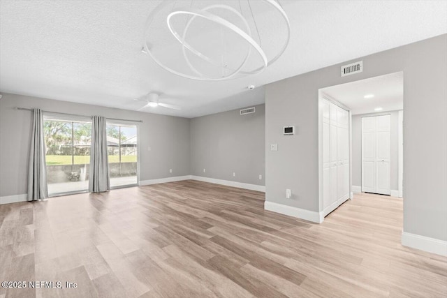 7142 Cypress Cove Rd Unit 39, Jacksonville, FL 32244 - spare room featuring baseboards, light wood-style flooring, ceiling fan, and a textured ceiling