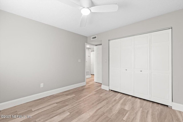 7142 Cypress Cove Rd Unit 39, Jacksonville, FL 32244 - unfurnished bedroom featuring light wood-type flooring, baseboards, a closet, and a ceiling fan