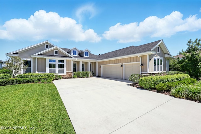 view of front facade featuring board and batten siding, a garage, driveway, a front yard, and a shingled roof
