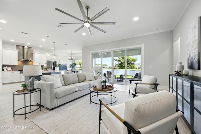 living area featuring ceiling fan, light wood finished floors, recessed lighting, crown molding, and a water view