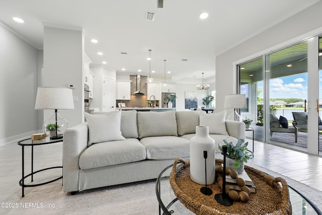 living area featuring recessed lighting, baseboards, a chandelier, and light wood finished floors