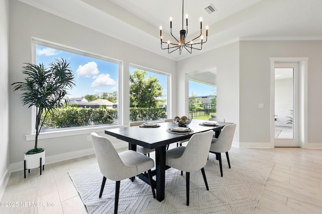 dining area featuring a chandelier, plenty of natural light, and baseboards