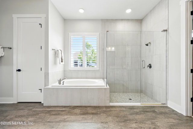 full bathroom with a stall shower and a garden tub