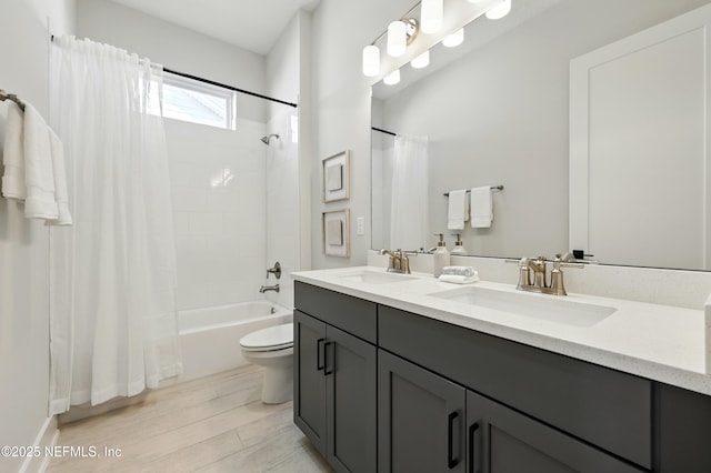 bathroom with shower / tub combo, double vanity, toilet, and wood finished floors