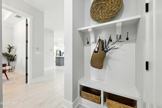 mudroom with light wood-type flooring and baseboards