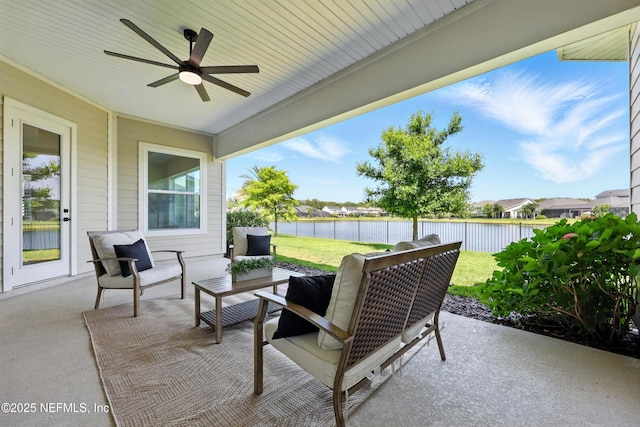 view of patio / terrace with a ceiling fan, a water view, and outdoor lounge area