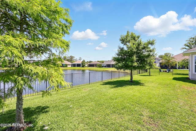 view of yard with a water view and a residential view