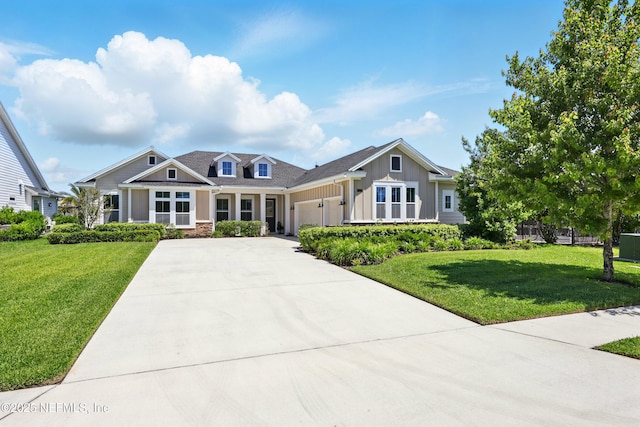 craftsman-style house with board and batten siding, a garage, driveway, and a front lawn