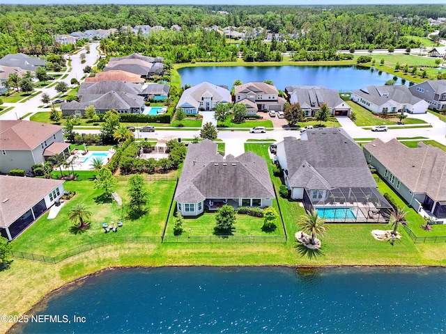 aerial view of residential area with a large body of water and a pool area