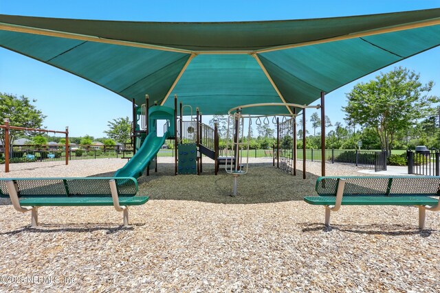 community jungle gym featuring fence