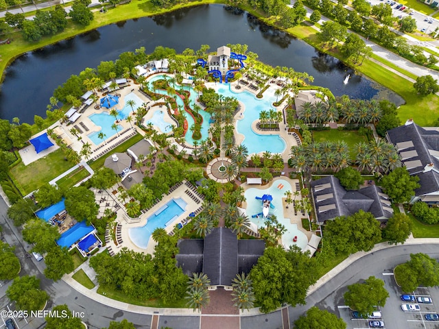 aerial view of a pool area and a nearby body of water