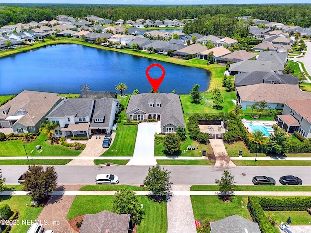 aerial perspective of suburban area with a nearby body of water