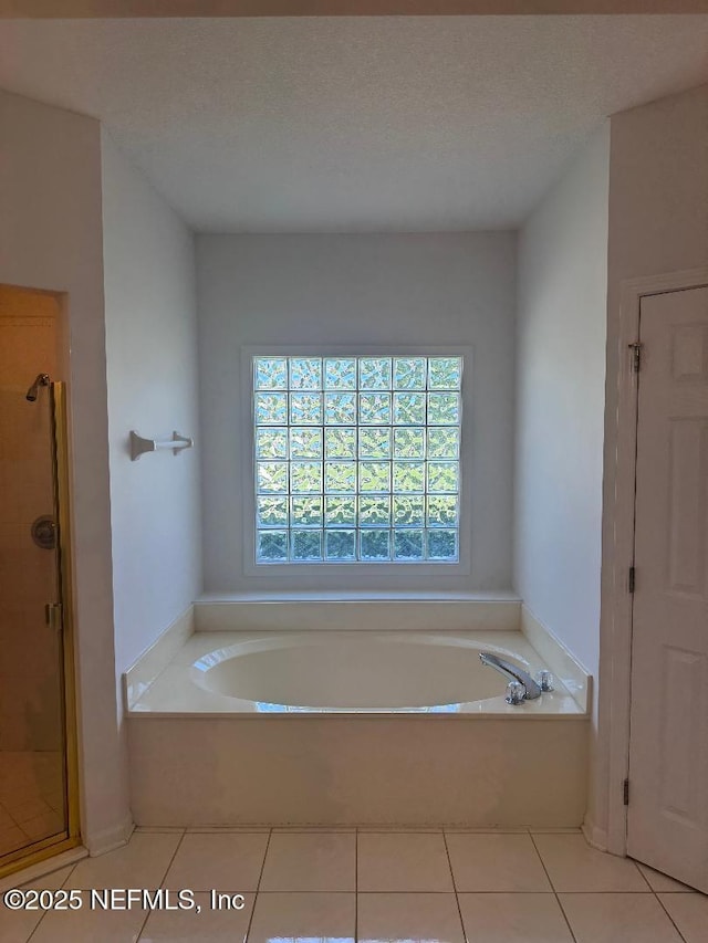 full bath with a shower stall, a garden tub, and tile patterned floors