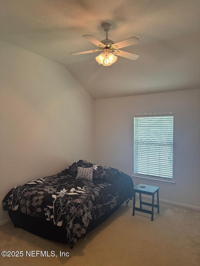 bedroom featuring carpet flooring, baseboards, lofted ceiling, and ceiling fan
