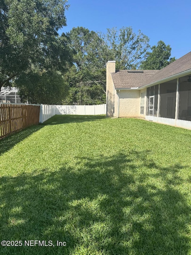 view of yard featuring a sunroom