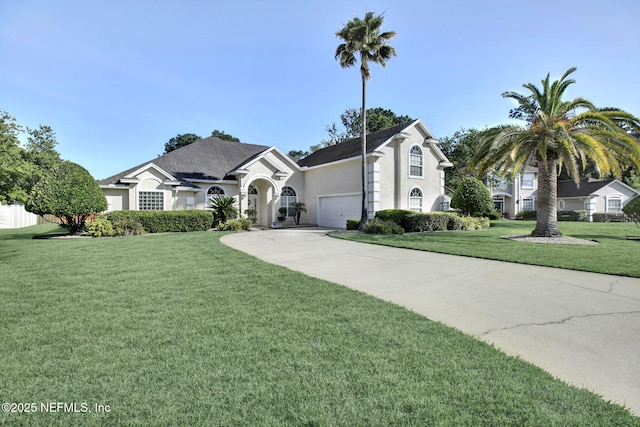 809 Lotus Ln N, Fruit Cove, FL 32259 - view of front of property featuring stucco siding, concrete driveway, a front yard, and a garage
