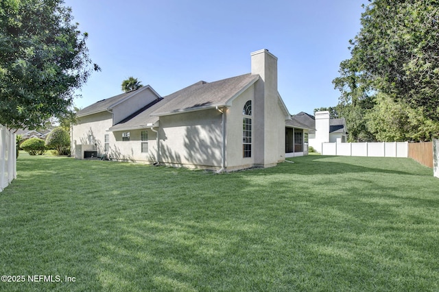809 Lotus Ln N, Fruit Cove, FL 32259 - rear view of house featuring a chimney and stucco siding