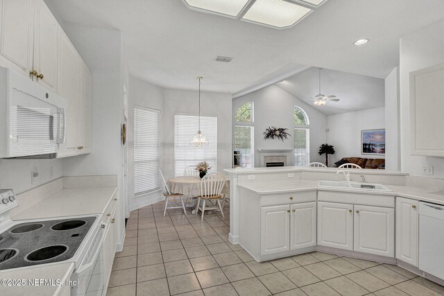 809 Lotus Ln N, Fruit Cove, FL 32259 - kitchen with white appliances, a sink, light tile patterned flooring, white cabinets, and vaulted ceiling
