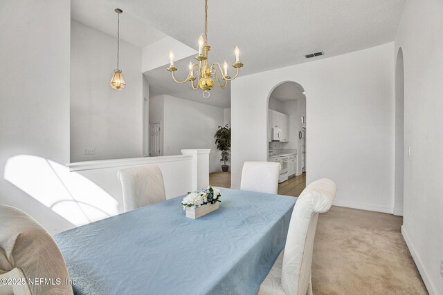 809 Lotus Ln N, Fruit Cove, FL 32259 - carpeted dining room with arched walkways, a chandelier, and baseboards