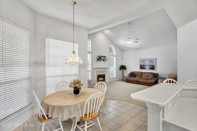 809 Lotus Ln N, Fruit Cove, FL 32259 - dining room with light tile patterned floors, light carpet, ceiling fan, a tiled fireplace, and high vaulted ceiling