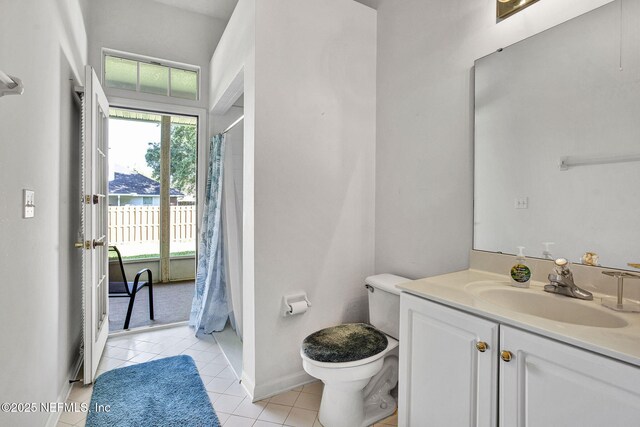 809 Lotus Ln N, Fruit Cove, FL 32259 - full bath featuring tile patterned flooring, toilet, vanity, baseboards, and shower / tub combo with curtain
