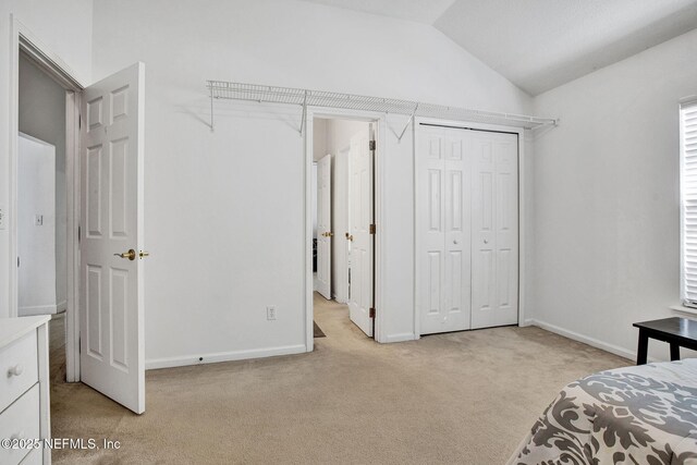 809 Lotus Ln N, Fruit Cove, FL 32259 - bedroom with lofted ceiling, light colored carpet, baseboards, and a closet