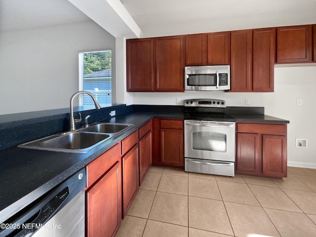 3020 Southbank Cir, Green Cove Springs, FL 32043 - kitchen featuring stainless steel appliances, a sink, dark countertops, and light tile patterned floors