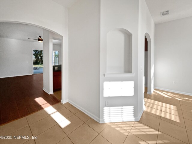 3020 Southbank Cir, Green Cove Springs, FL 32043 - corridor featuring arched walkways, tile patterned floors, and baseboards