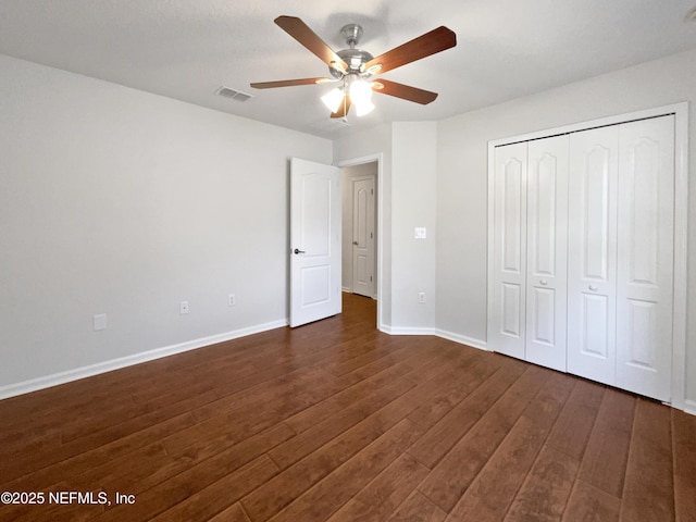 3020 Southbank Cir, Green Cove Springs, FL 32043 - unfurnished bedroom featuring dark wood-style flooring, baseboards, a closet, and a ceiling fan
