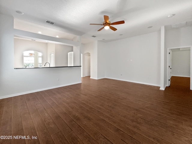 3020 Southbank Cir, Green Cove Springs, FL 32043 - unfurnished living room with ceiling fan, dark wood-type flooring, arched walkways, baseboards, and recessed lighting