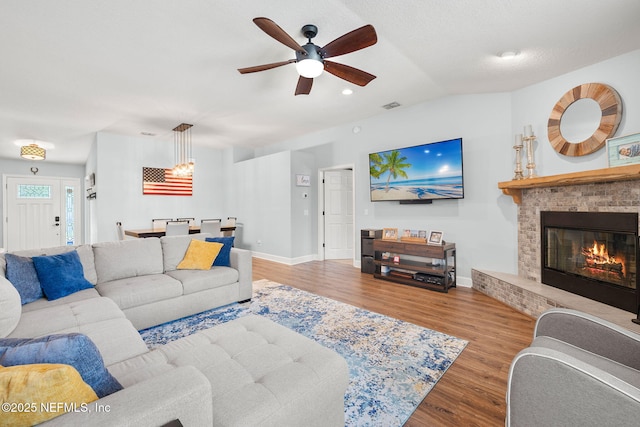 1770 High Brook Ct, Jacksonville, FL 32225 - living room with ceiling fan, wood finished floors, vaulted ceiling, a brick fireplace, and baseboards